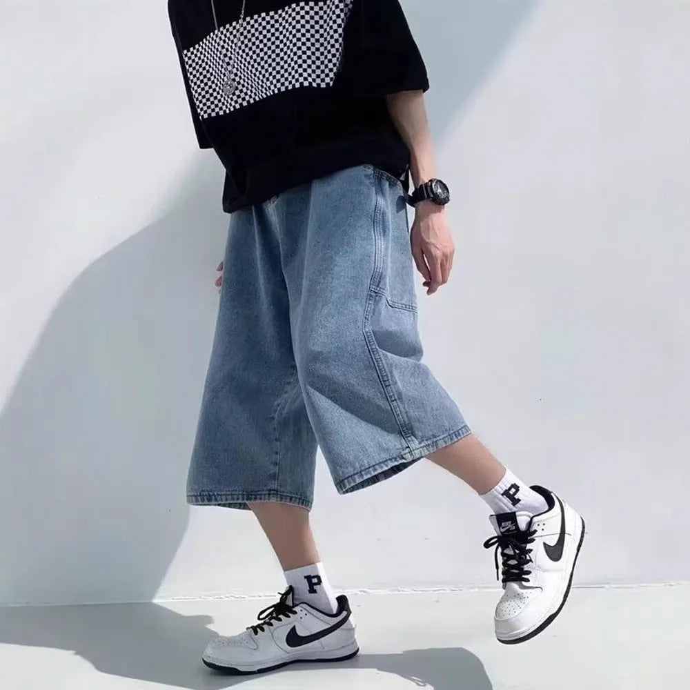 Blue men's washed denim pirate shorts with a high waist and cropped length on a neutral background.