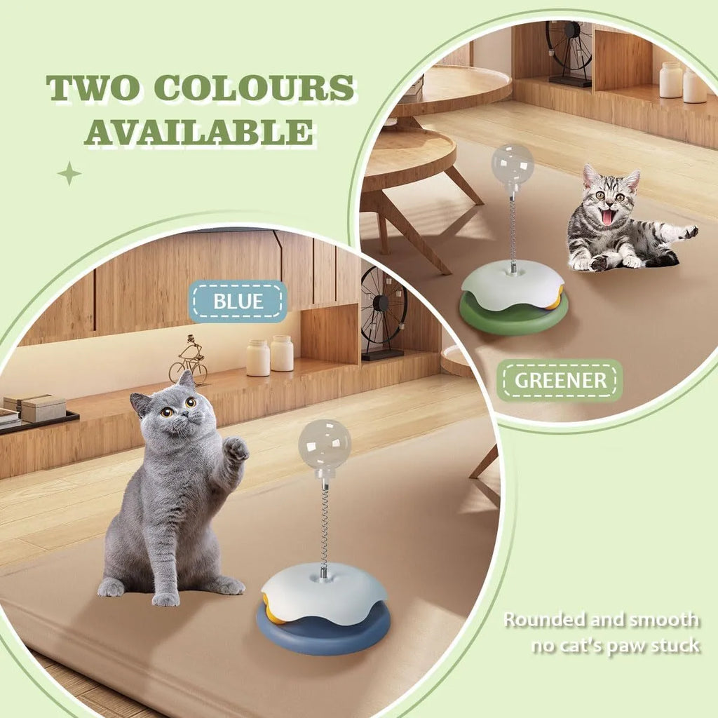 Blue and green interactive cat treat dispenser toy with a track ball on a wooden floor.