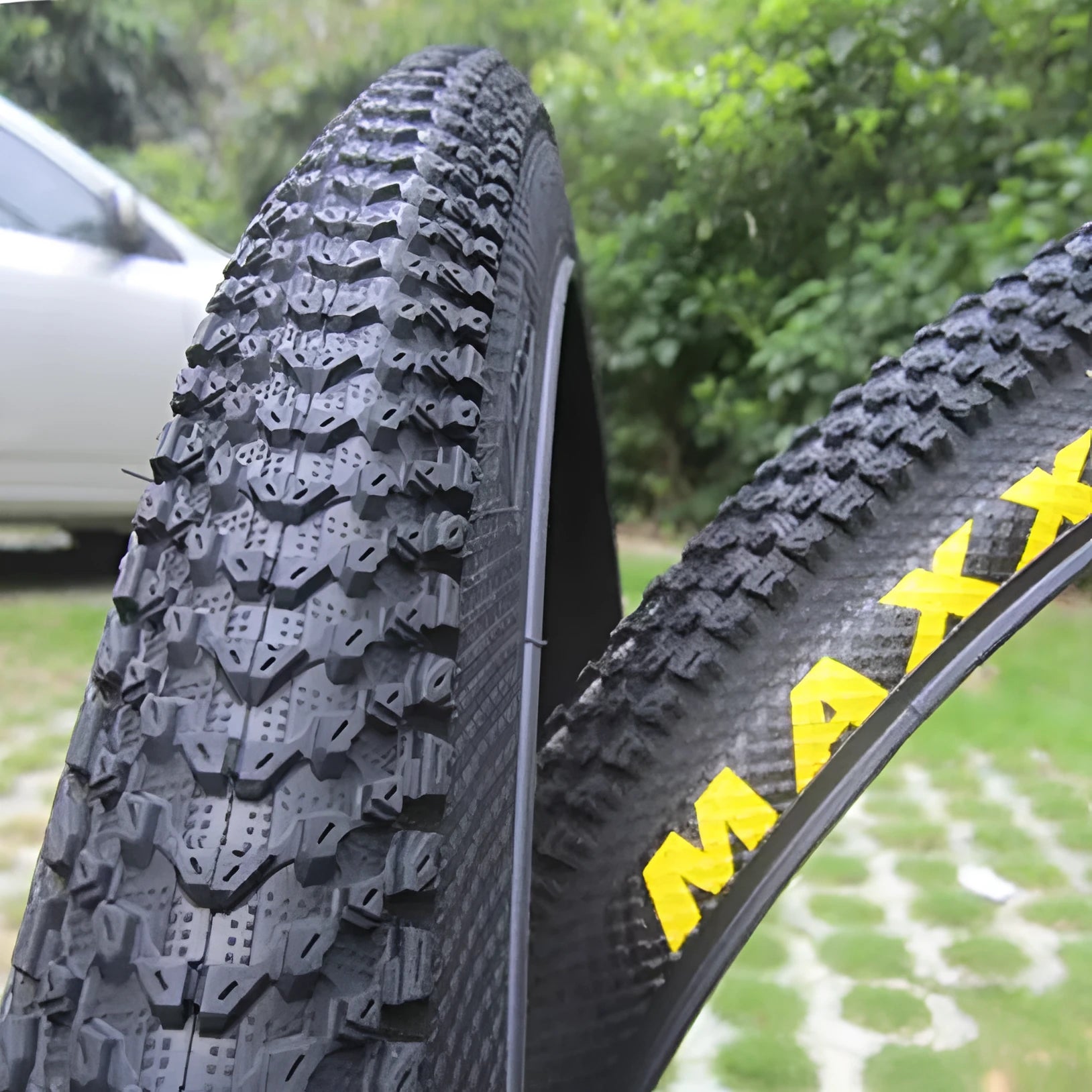 Ultralight mountain bike tyre with knobbly tread, shown in multiple size options including 26, 27.5 and 29 inch.