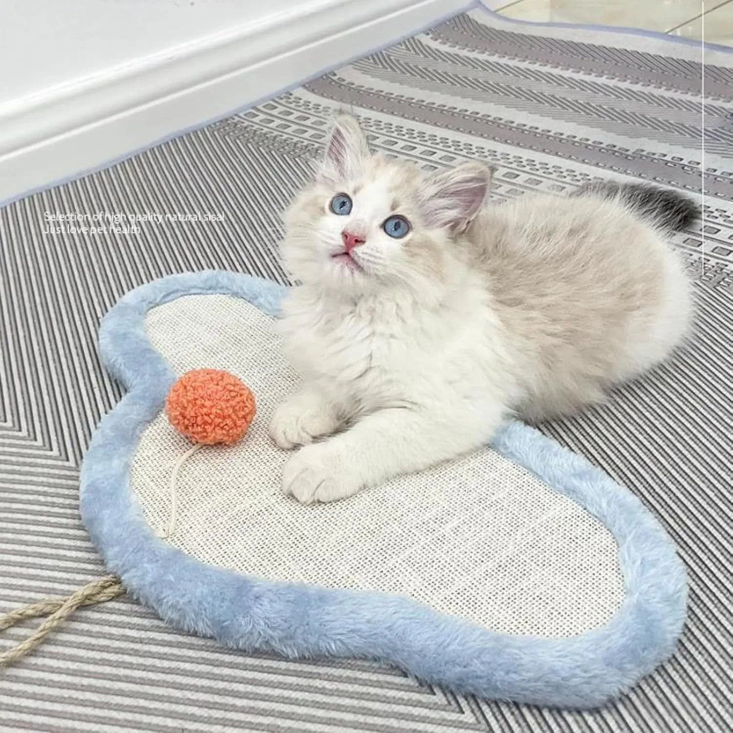 White wall mounted cat scratching mat with cartoon sleeping cat design made from natural sisal.