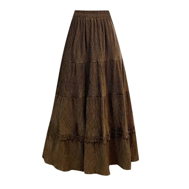 Korean-style beige corduroy A-line midi skirt with an elastic waistband laid flat.