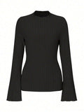 Black slim fit long sleeve top with lantern sleeves and a round neckline on a mannequin.