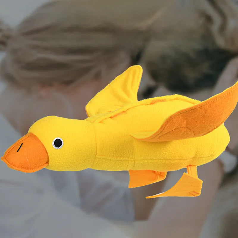 Yellow teddy dog training toy with integrated duck doll and food leak compartments