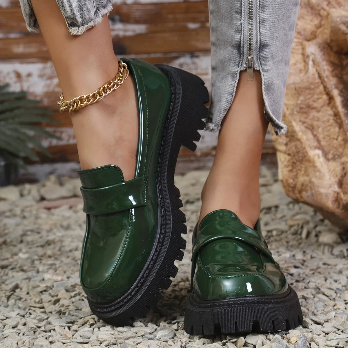 Women's black slip-on loafers with a chunky platform heel and rubber sole on a neutral background.