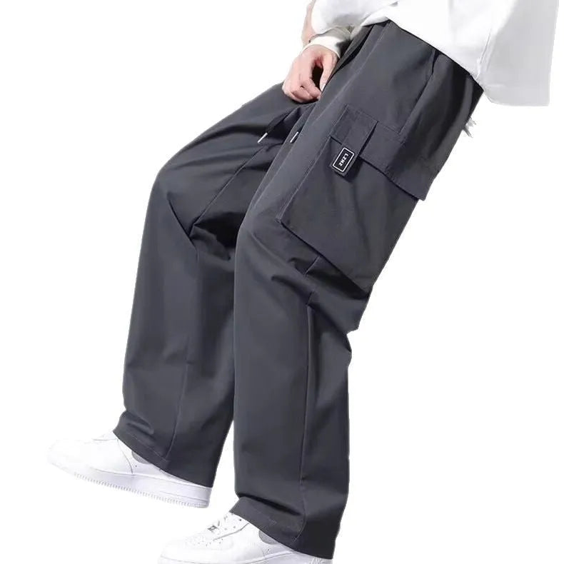 Boys' straight leg cargo pants in army green with large pockets and a drawstring waistband.