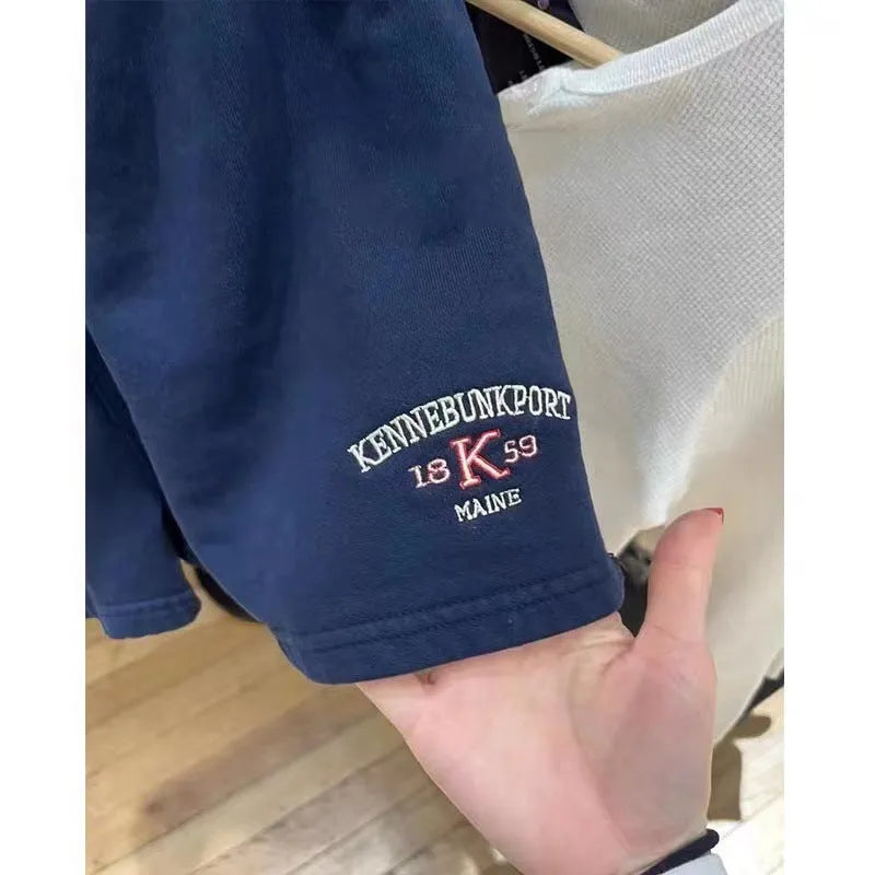Dark blue cotton sports shorts with white flag embroidery and navy contrast detailing