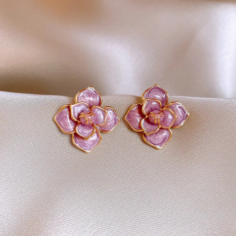 Close-up of gold plated purple oil-spot glaze flower stud earrings on copper base with needle post