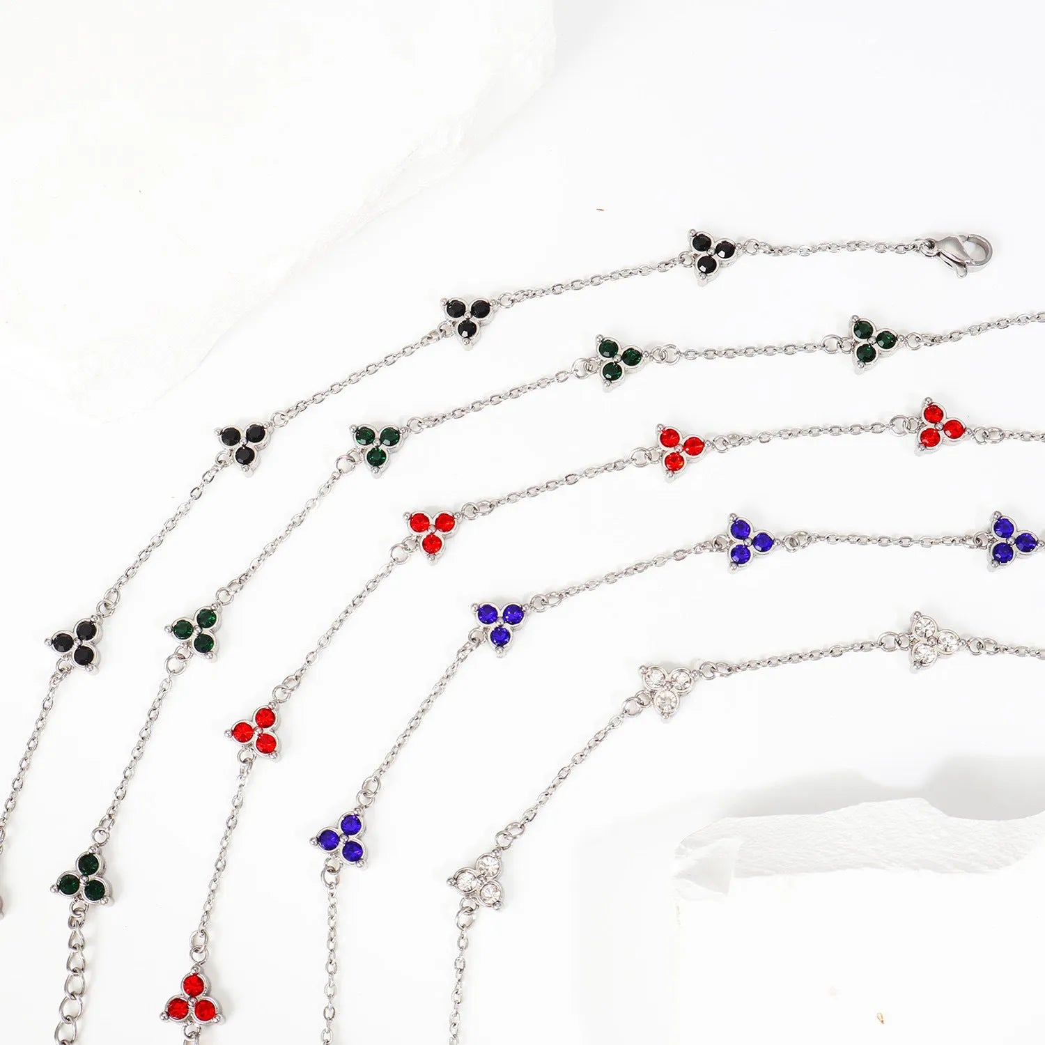 Women's stainless steel geometric bracelet with triangle design and coloured zircon stones.