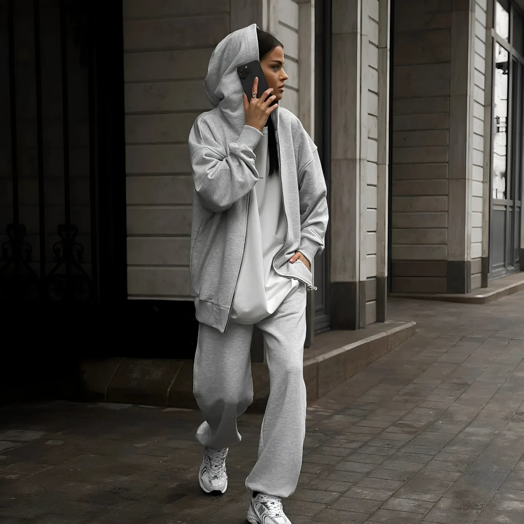 Women's loose fit polyester two-piece set with long-sleeved coat and trousers in a solid colour.