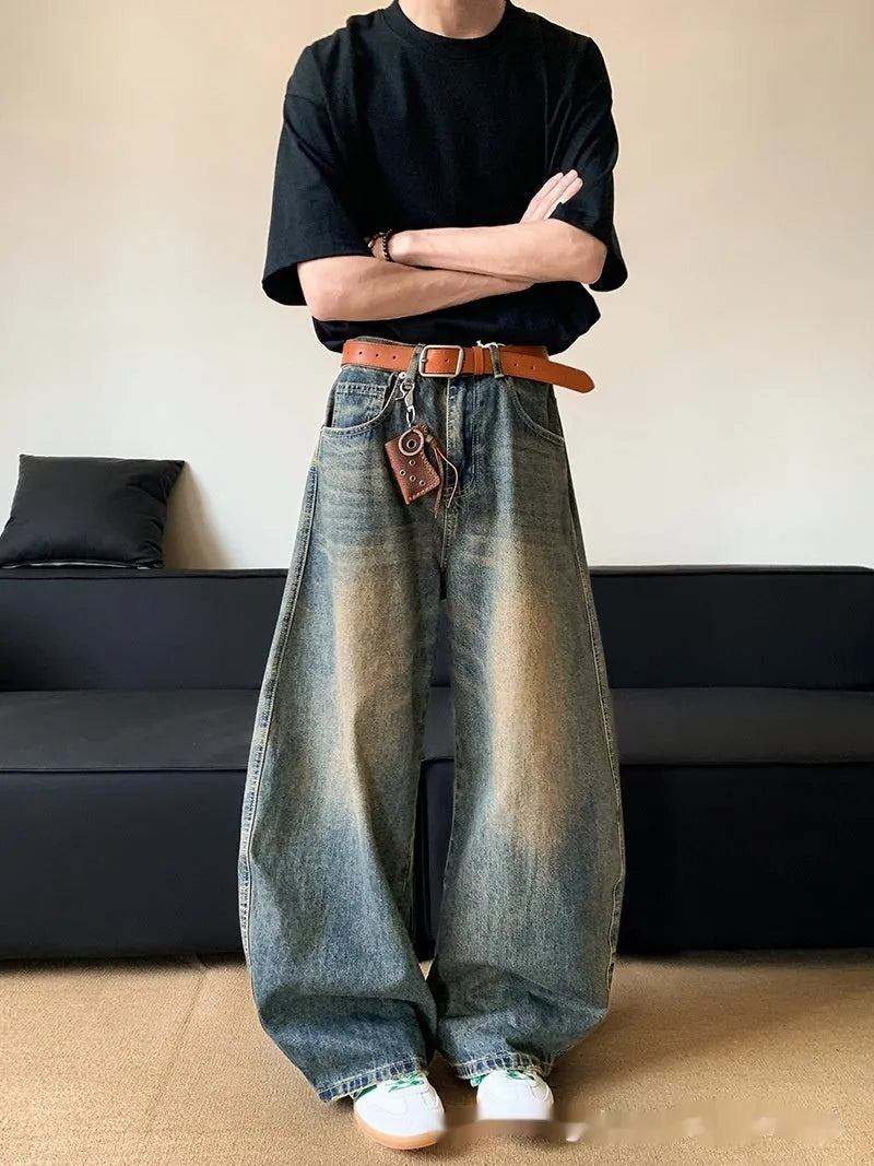 Men's distressed retro blue denim trousers with wide-leg silhouette and micro-elastic cotton-blend fabric