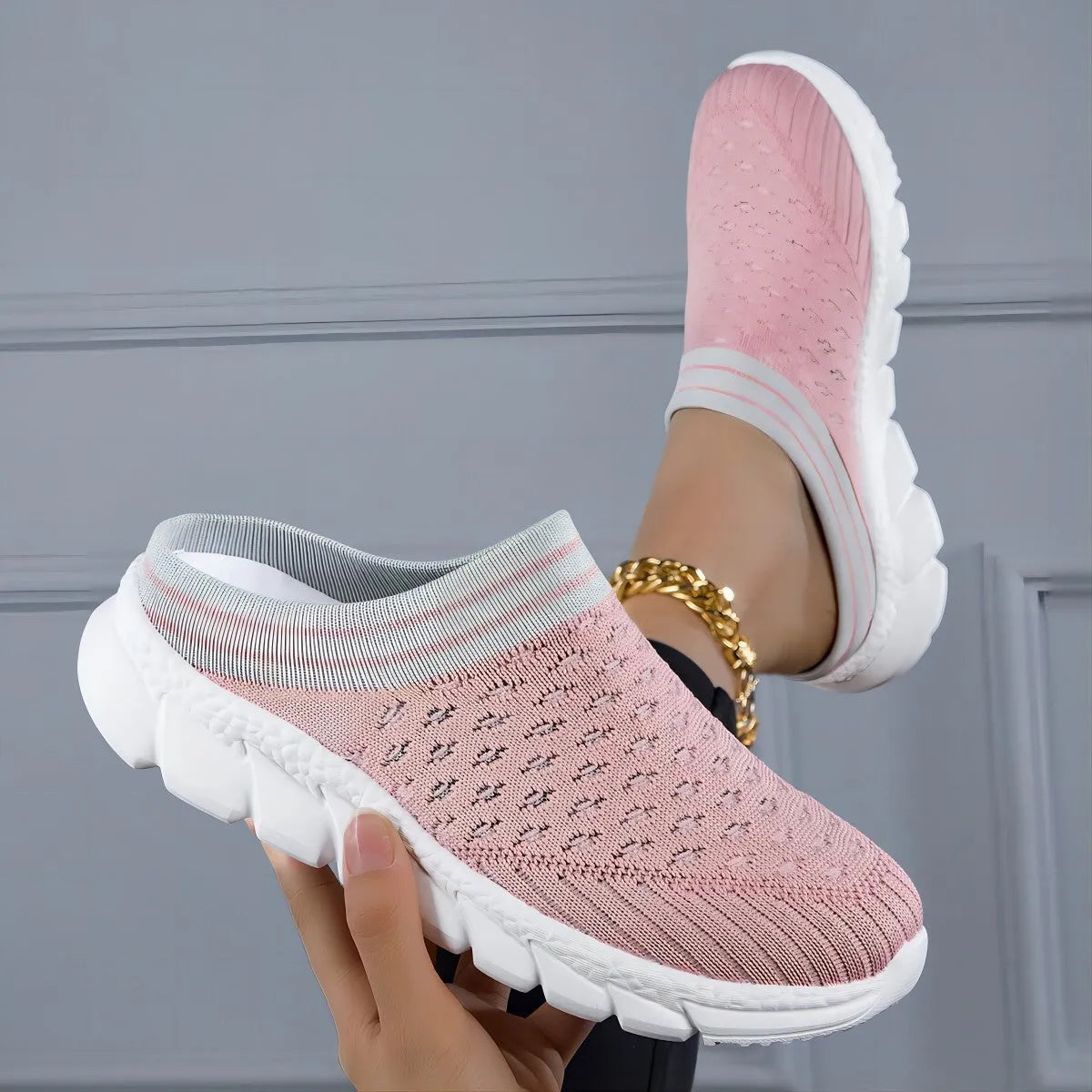 Black, pink, and purple striped Flyknit women's sports slippers with hollowed-out design on a viscose sole.