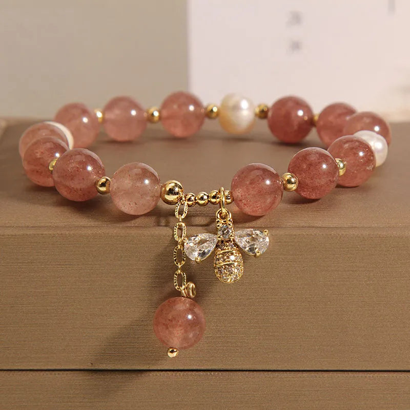 Women's freshwater pearl and strawberry quartz bracelet with zircon accents on wrist