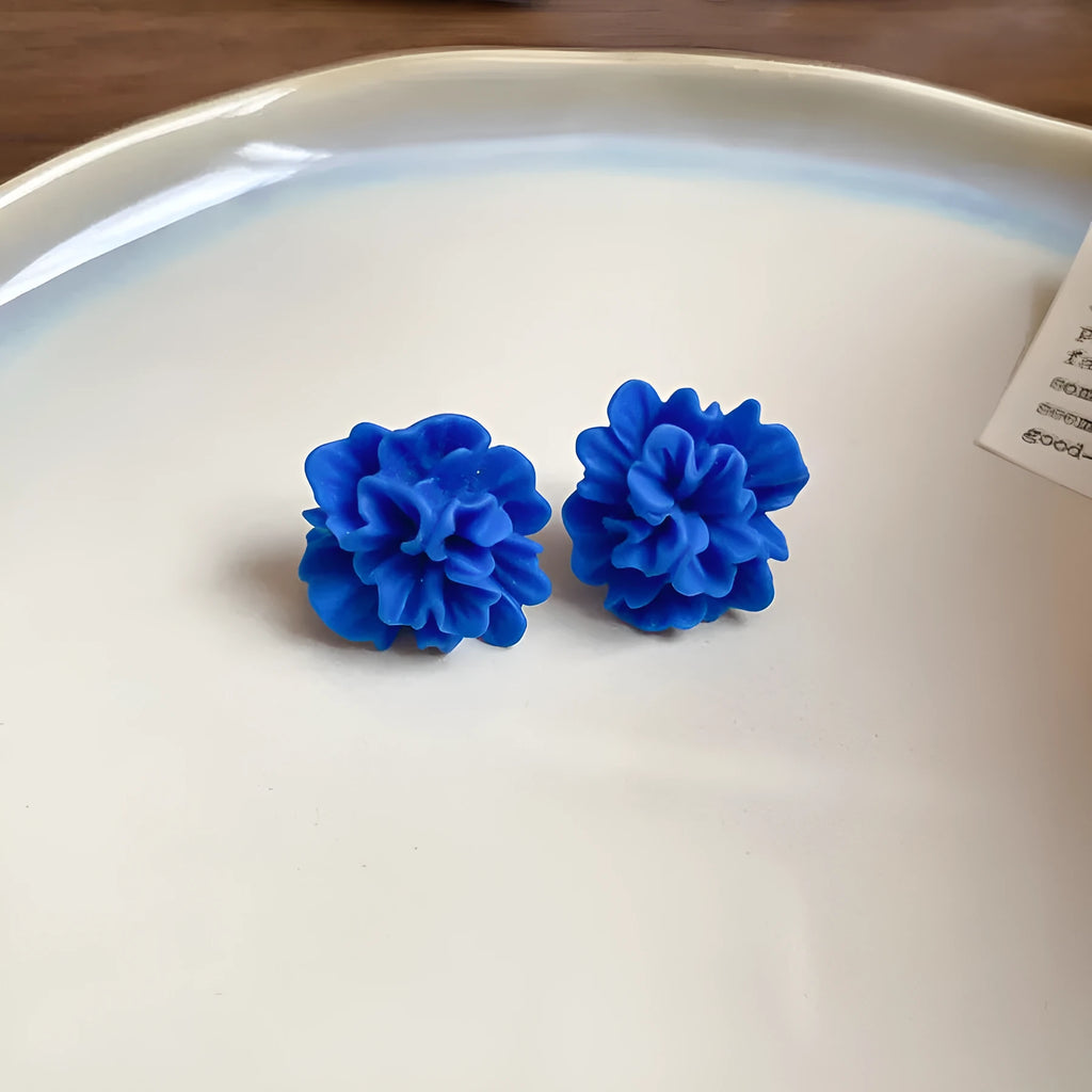 Women's geometric fabric earrings with blue resin flower detailing and silver needle colour