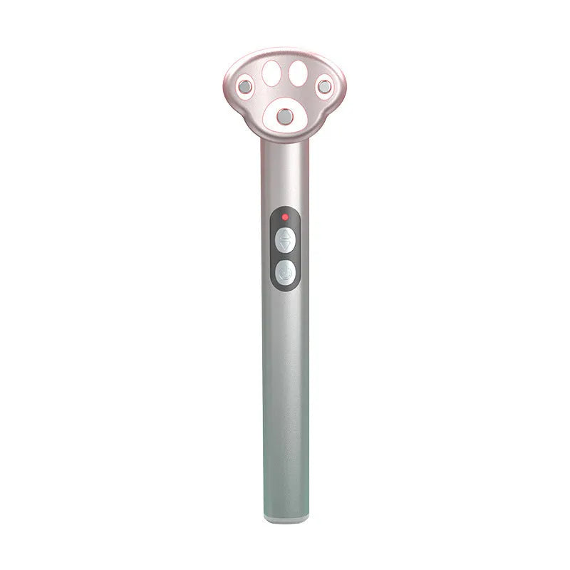 Gradient pink cats paw shaped micro-current eye massager on a white background