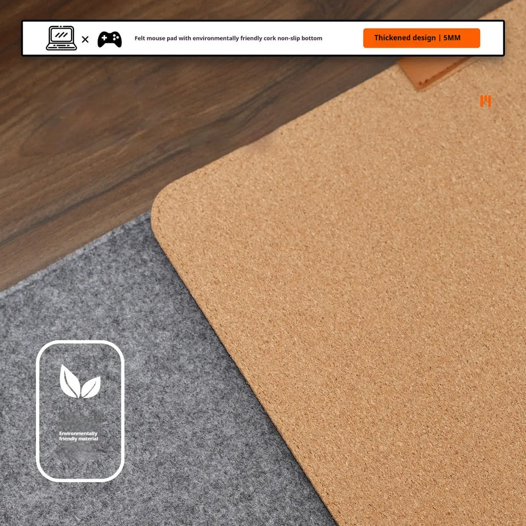 Simple grey felt and cork desk mat in an oversized rectangle shape on a wooden desk.