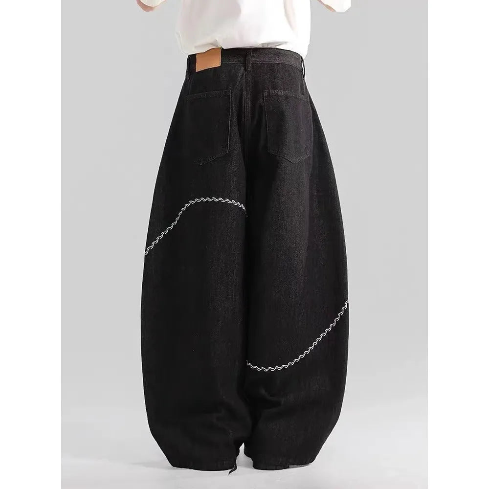 Black straight-leg denim trousers with mid-waist design and zip fly closure
