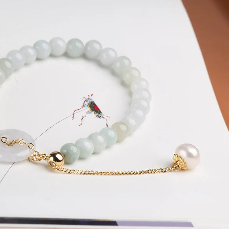 Natural emerald green jade round pendant on a women's bracelet with a geometric peace buckle.
