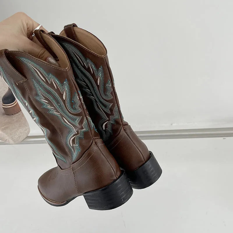 Brown women's mid-calf Martin boots with embroidered detail on the upper and a low square heel.