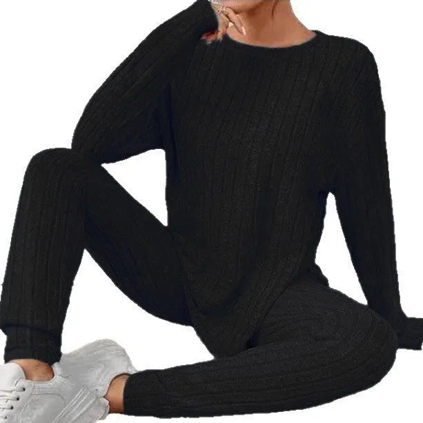 Black sunken stripe polyester two-piece loungewear set with top and pants.