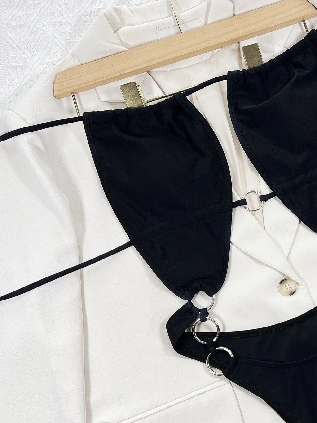 Black women's one-piece swimsuit with steel ring detailing and sleeveless design