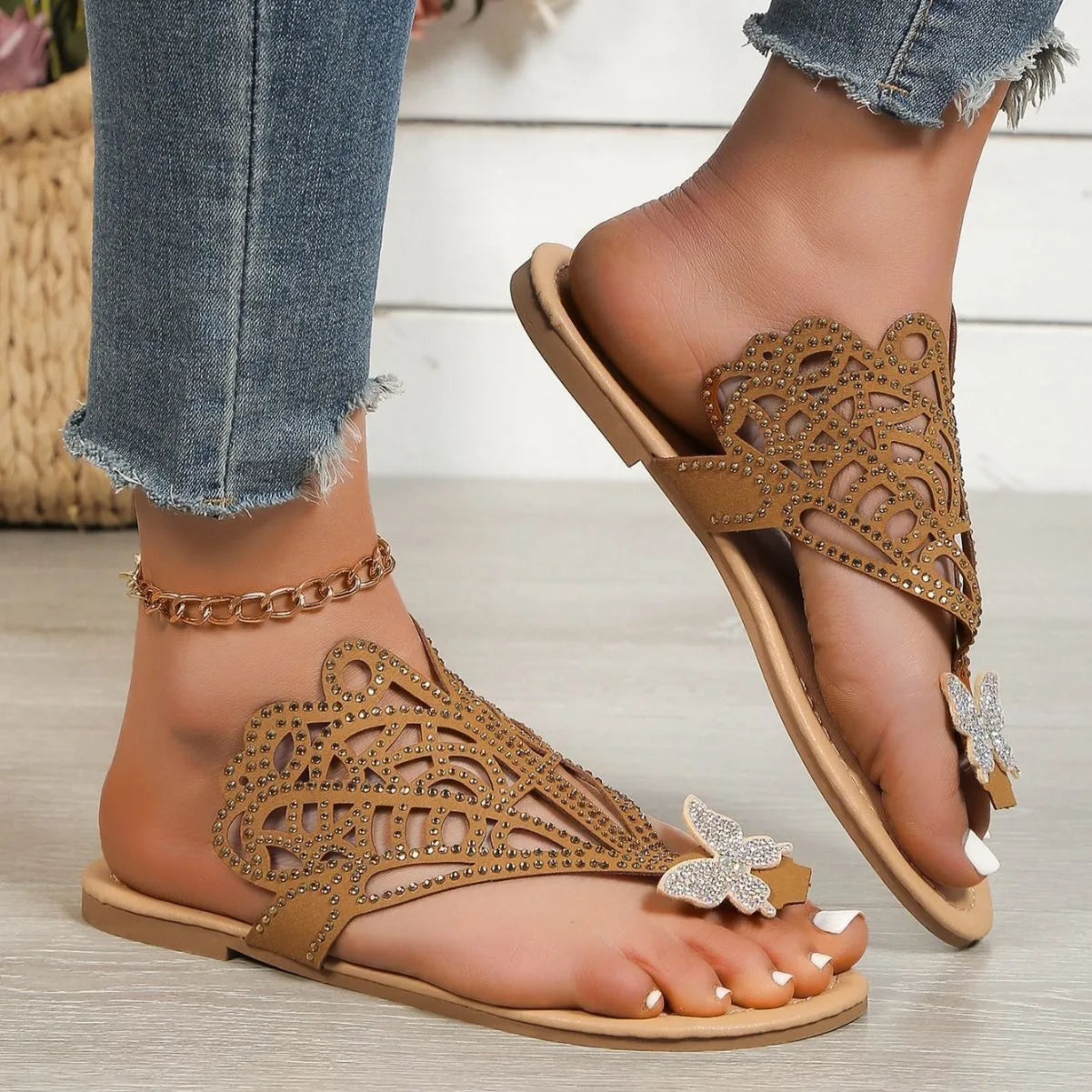 Women's black slip-on sandals with gold rhinestone decoration on the toe strap