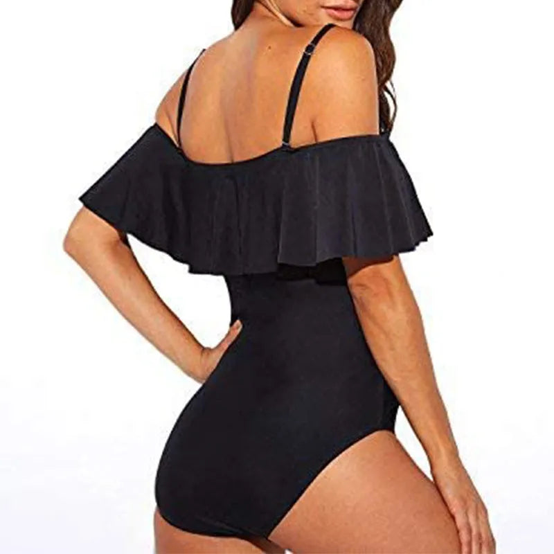 Black one-piece swimsuit with cut-out design and ruffled straps on the tube top