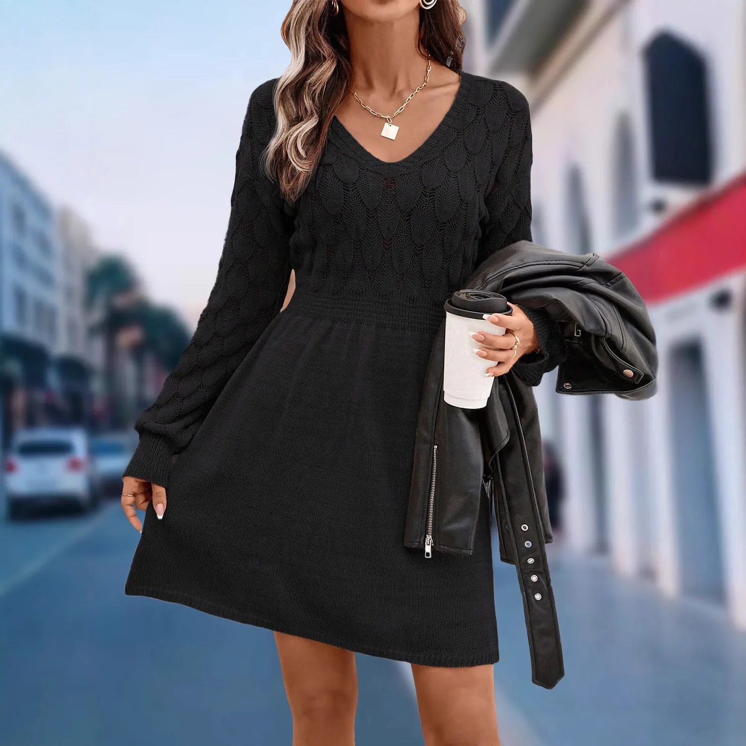 Long sleeve v-neck dress in apricot with artistic 3D pattern details and a high-waisted midi silhouette.