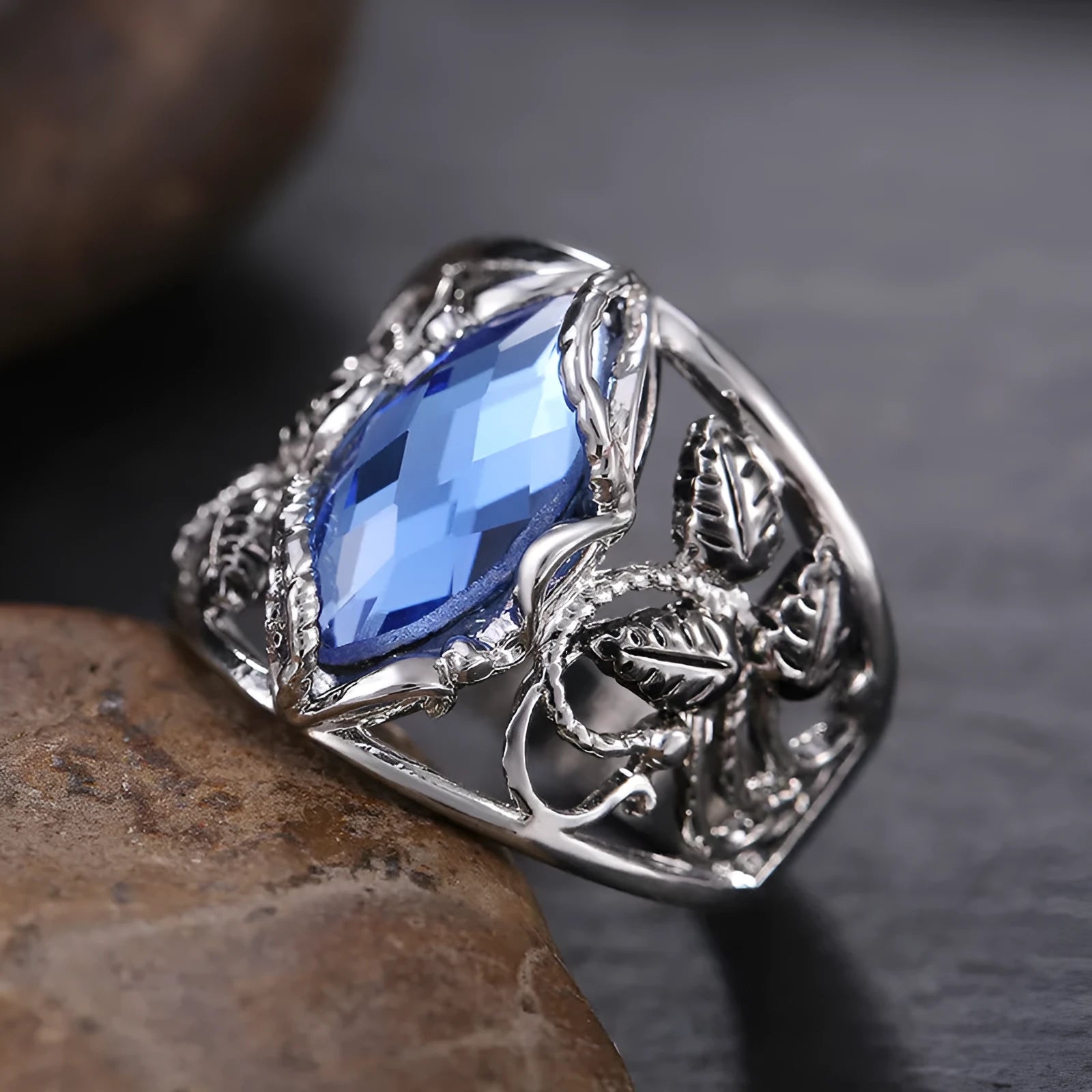 Blue crystal horse eye geometric ring on alloy band showing side profile