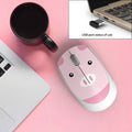 Mini wireless cartoon mouse in blue rabbit design next to USB receiver on a laptop.
