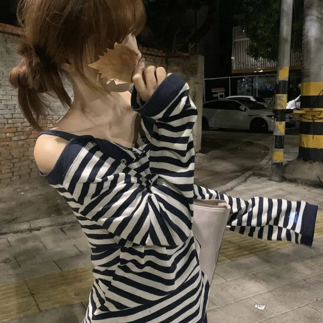Dark blue oversized women's long-sleeved t-shirt with Korean-style embroidery and button details.