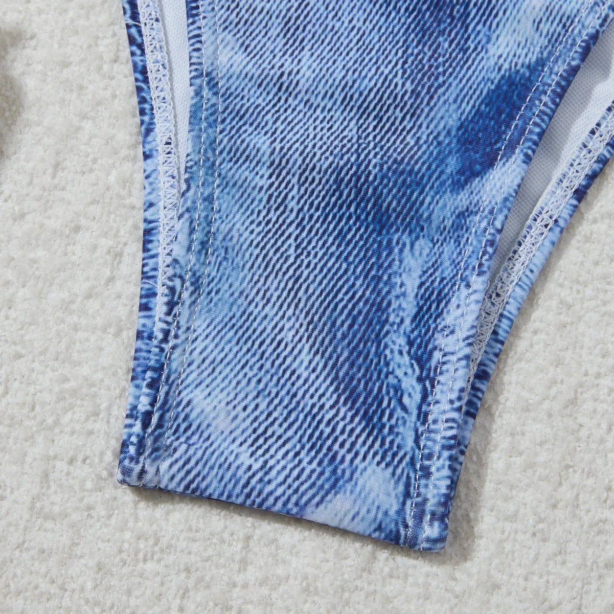 Women's denim blue strappy bikini set with printed design and two-piece swimwear construction