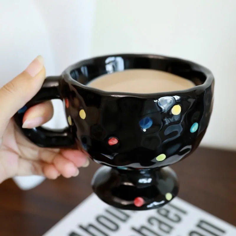 Hand-pinched ceramic mug with irregular shape and solid-colour finish, approximately 14.5cm tall