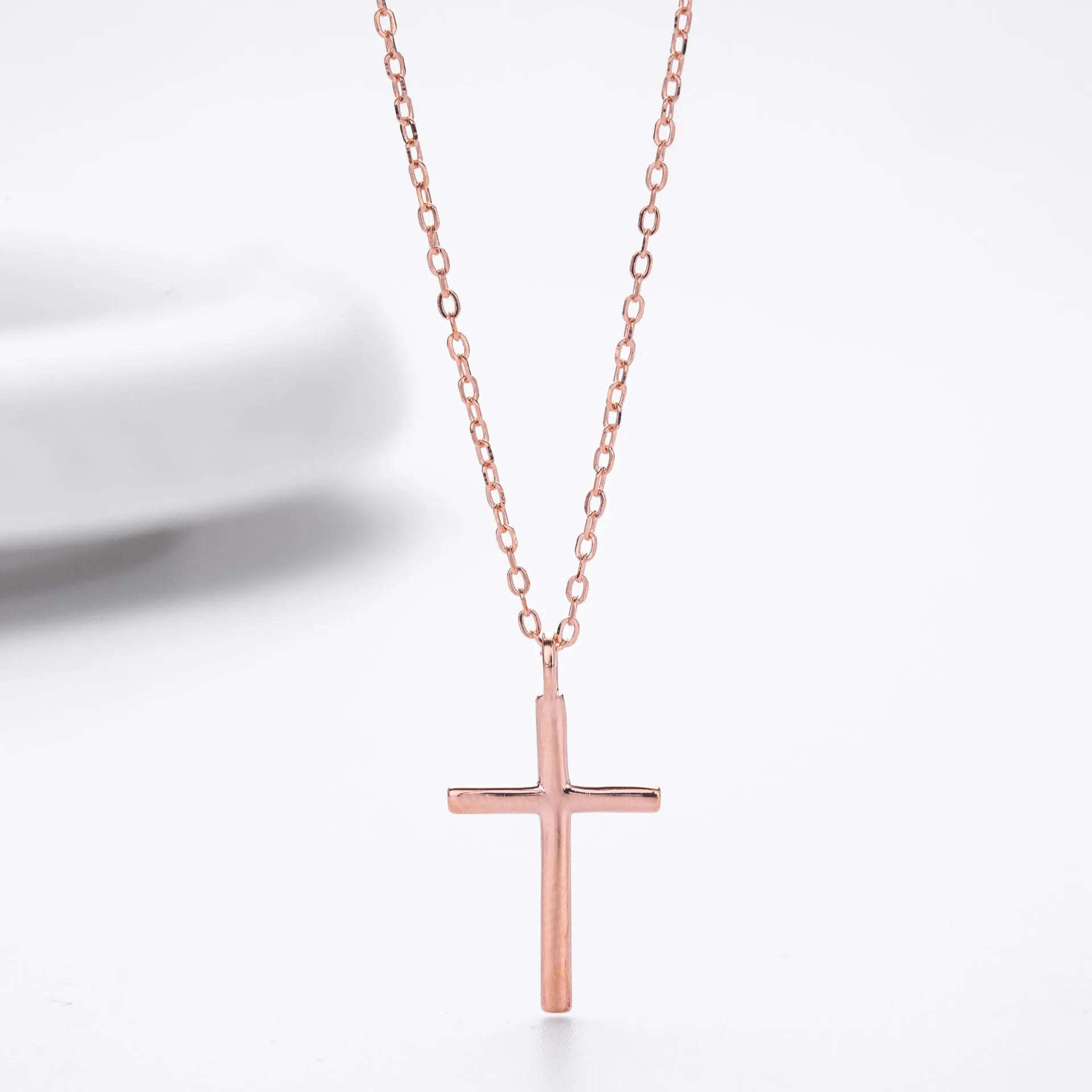 S925 sterling silver necklace with a simple glossy cross pendant on an adjustable O-shaped chain.