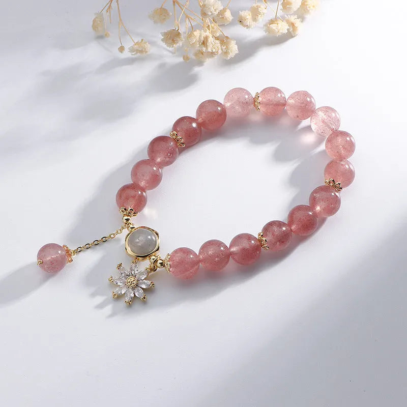 Strawberry quartz Mori style bracelet with electroplated floral details on a white background