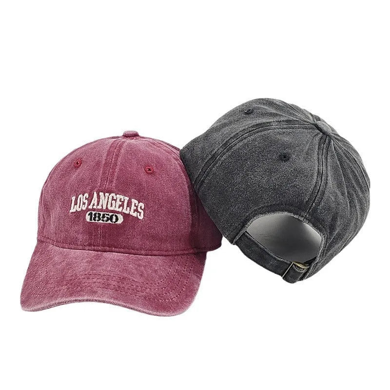 Retro distressed peaked cap with embroidered letters and adjustable strap in multiple colour options