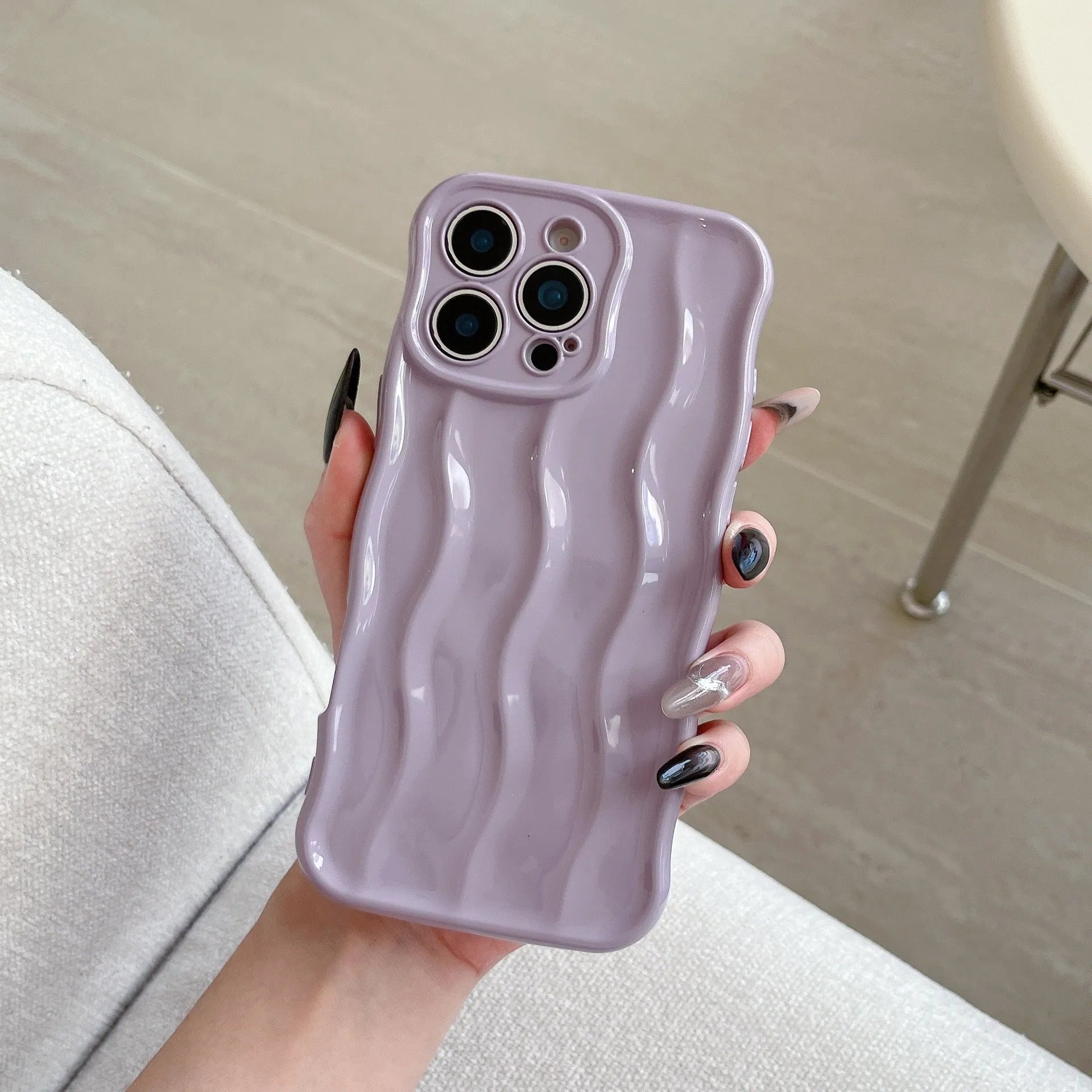 Electroplated wave stripe pattern on a black TPU protective case for iPhone 17 Pro Max.
