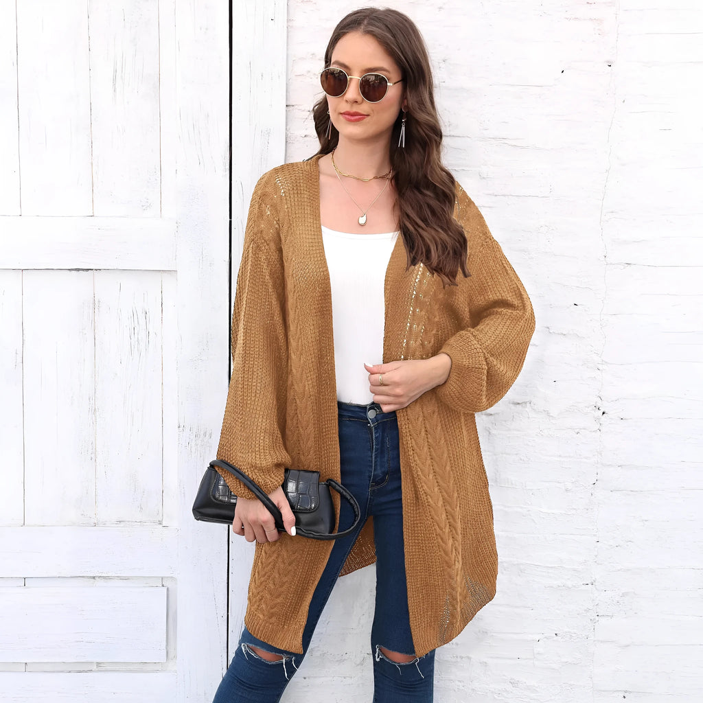 A woman's loose-fitting, solid-colour acrylic sweater coat on a hanger.