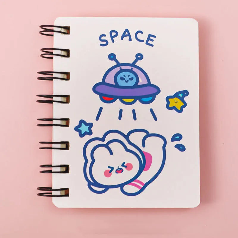 Small astronaut-themed flipper notebook showing one of four cover designs: Astronaut Bear, Planet Teddy, Space Cat, or UFO.