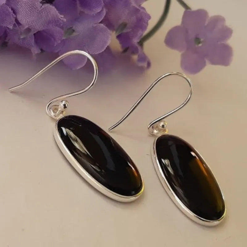 Black women's earrings with an oval black agate pendant on 925 silver, in a Chinese geometric style.