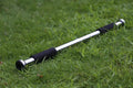 Adjustable steel pull-up bar extended across doorway showing parallel grip positions