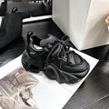Women's creamy white wedge sneakers with cross strap design and lace-up front on a grey background.