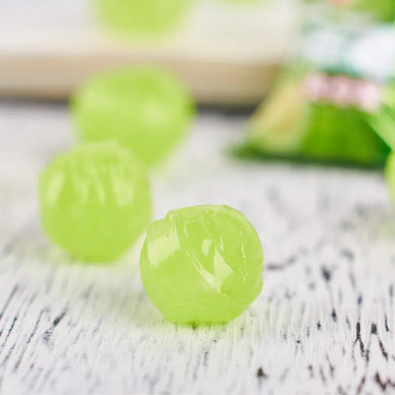 Bag of mixed hard candies in plum, guava, and tangerine peel flavours, total weight 1055g.