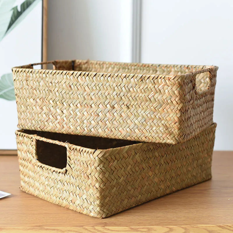 Handmade straw woven rectangular storage basket in natural grass fibre on a shelf
