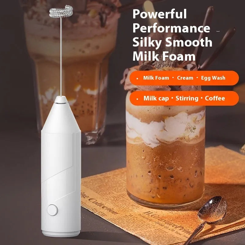 Handheld USB rechargeable milk frother in black, white, or khaki colour on a kitchen counter.