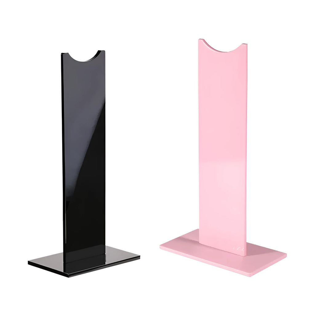 Black detachable head-mounted gaming headset stand with a silicone base on a wooden desk.