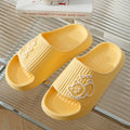 Women's cat platform slippers in pink with thick EVA sole, shown on a wooden floor.