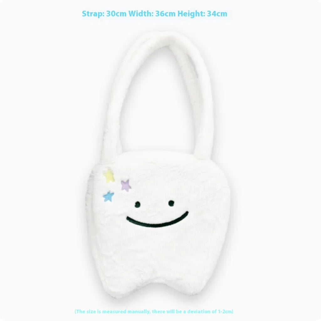 White plush tote bag with tooth decoration and shoulder strap showing zip opening