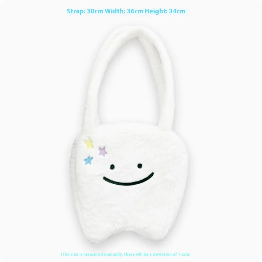 White plush tote bag with tooth decoration and shoulder strap showing zip opening