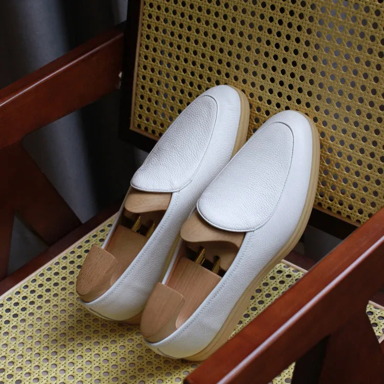 Men's brown genuine leather British handmade loafers on a white background.