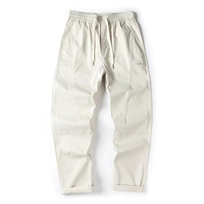 Women's milky white cotton wide-leg trousers with a straight pants-mouth opening, laid flat.